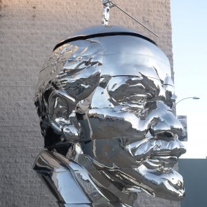 Miss Mao trying to poise herself at the top of Lenin’s head